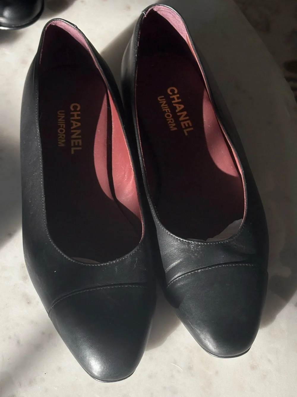 CHANEL Black Leather Ballet Flats with Gold CC Heel Accent